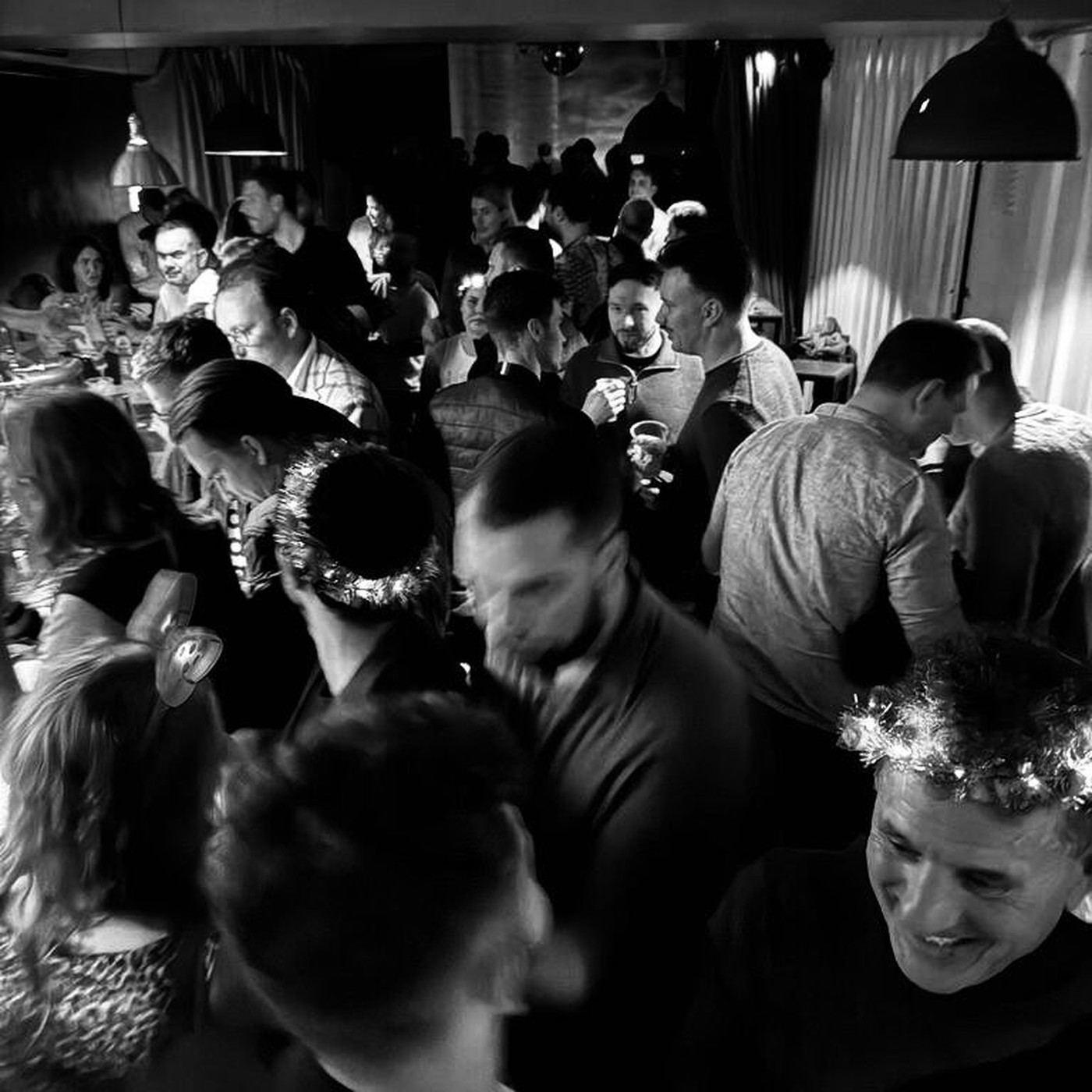 A packed room of people talking and celebrating together