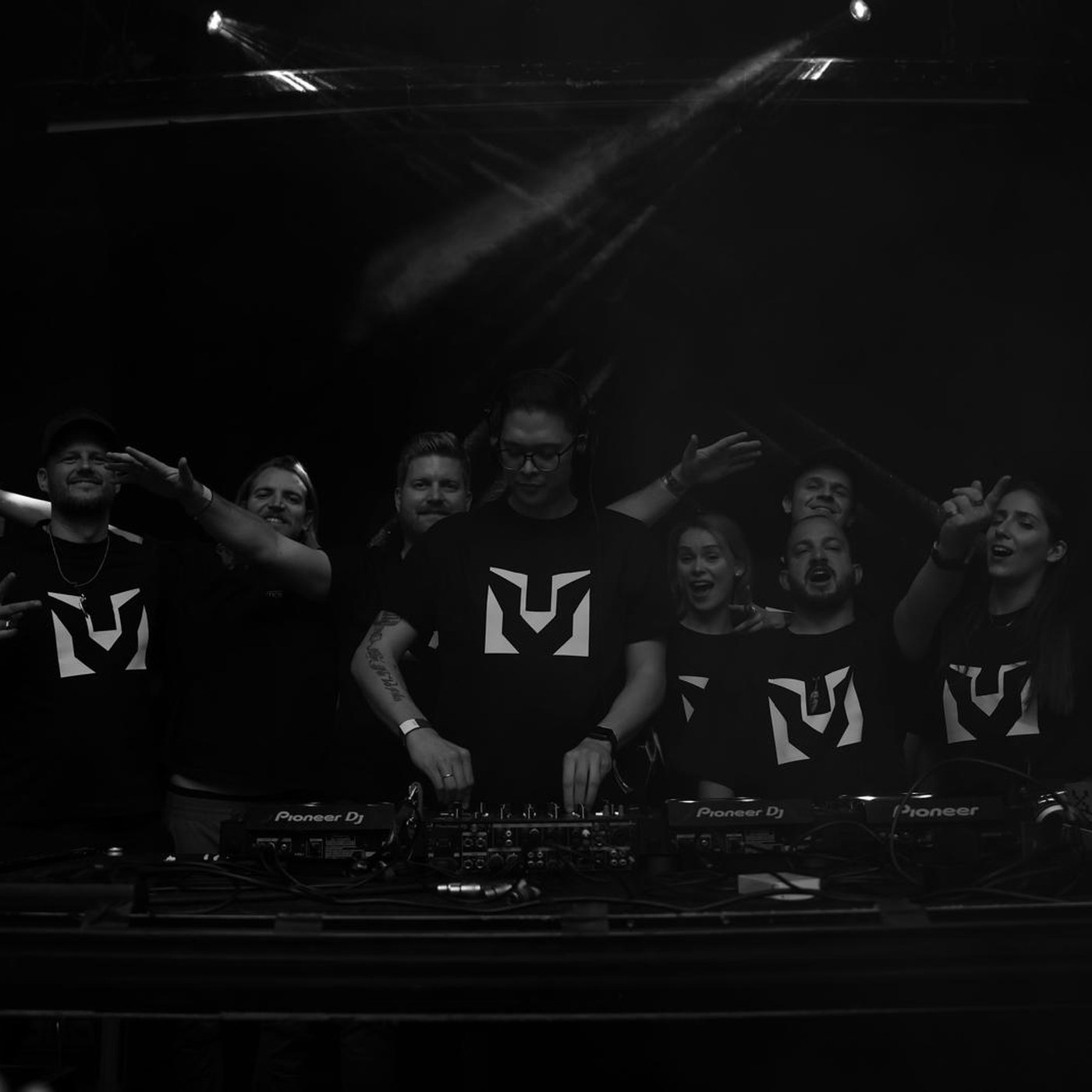 The District 909 crew behind the decks in a dark club
